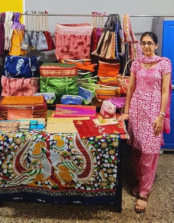 Shreya Bakhle at her tailoring studio in Ponda, Goa, showcasing handcrafted eco-friendly bags and upcycled saree creations